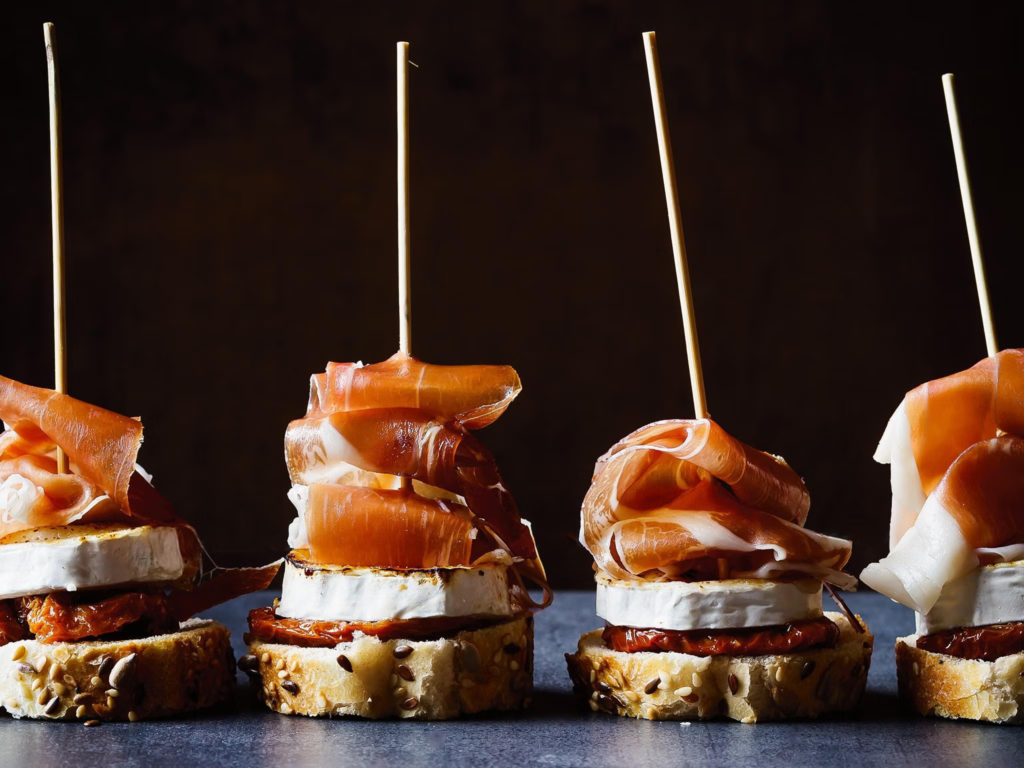 In the Basque Country, spanish street food is synonymous with pintxos—small snacks similar to tapas, typically served on a slice of bread and held together with a toothpick