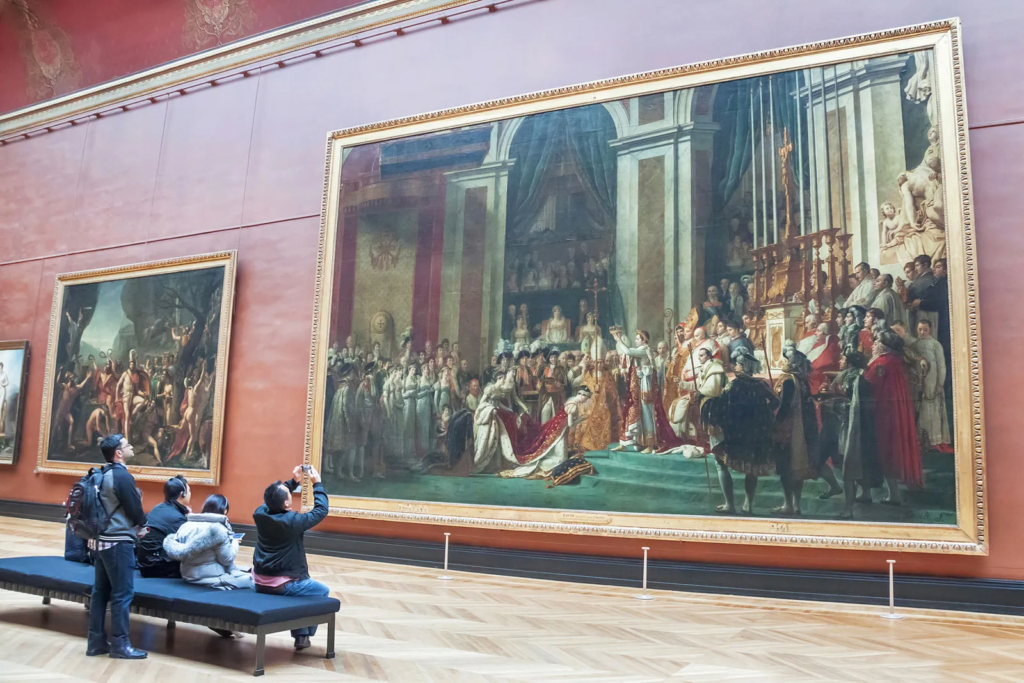 The Coronation of Napoleon by Jacques-Louis David is one of the largest paintings in The Louvre Museum , and it depicts the moment when Napoleon Bonaparte crowned himself Emperor of the French