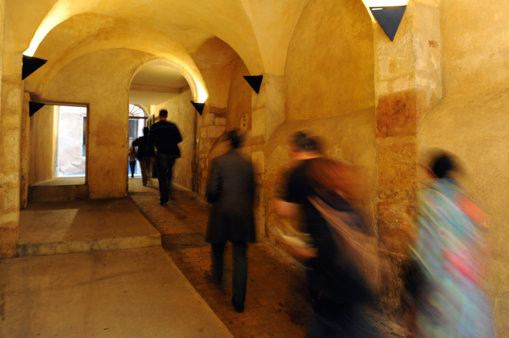 The traboules of Vieux Lyon are a series of hidden passageways that run through buildings and courtyards, originally used by silk workers to transport their goods while avoiding the rain