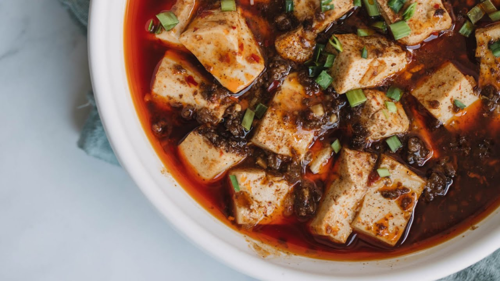 Mapo Tofu is a signature dish of Sichuan cuisine, known for its bold, spicy flavors. The dish consists of soft tofu set in a spicy, oily sauce made from fermented broad bean paste and ground beef or pork