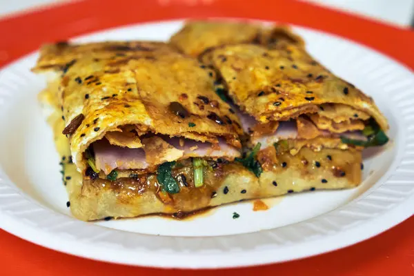 Jianbing is one of the most popular China Street Food , often eaten for breakfast