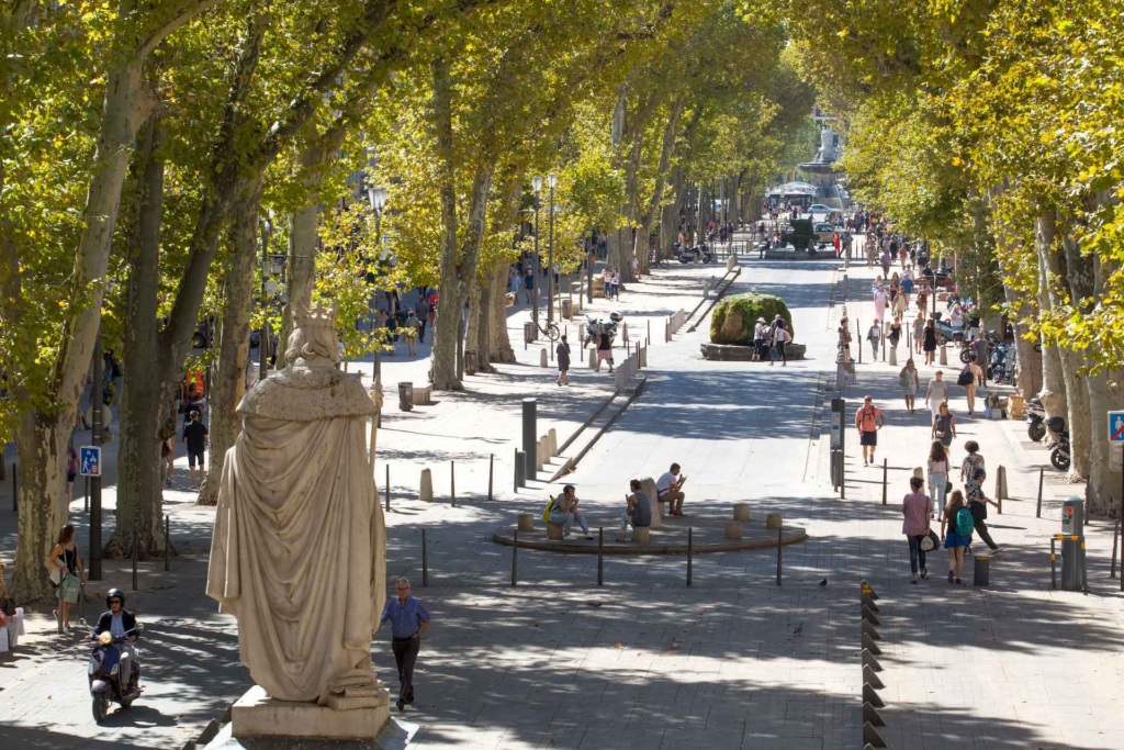 The heart of Aix-en-Provence is the Cours Mirabeau, a wide and lively boulevard lined with elegant plane trees, historic mansions, cafés, and boutiques