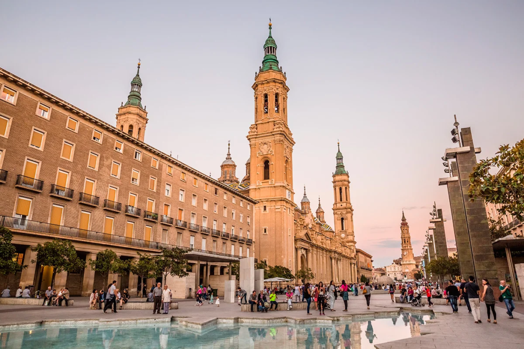 Plaza del Pilar is the bustling heart of Zaragoza, surrounded by iconic landmarks such as the Basilica del Pilar, the Cathedral of San Salvador (La Seo), and the Fountain of Hispanidad